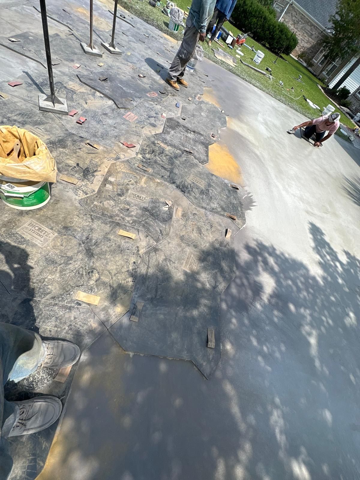 A person is riding a skateboard on a concrete surface.