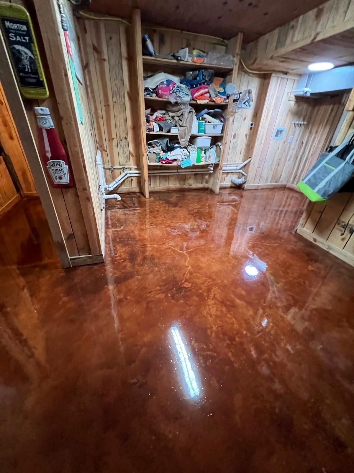A room with a shiny metallic floor and wooden walls.