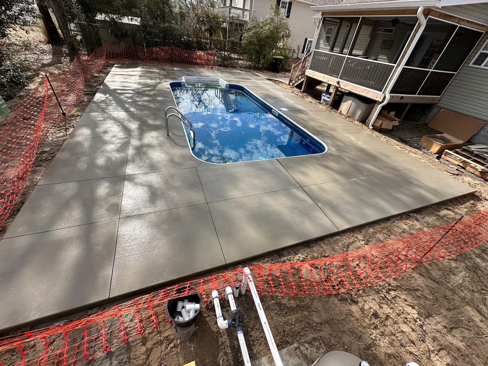 A swimming pool is being built in the backyard of a house.