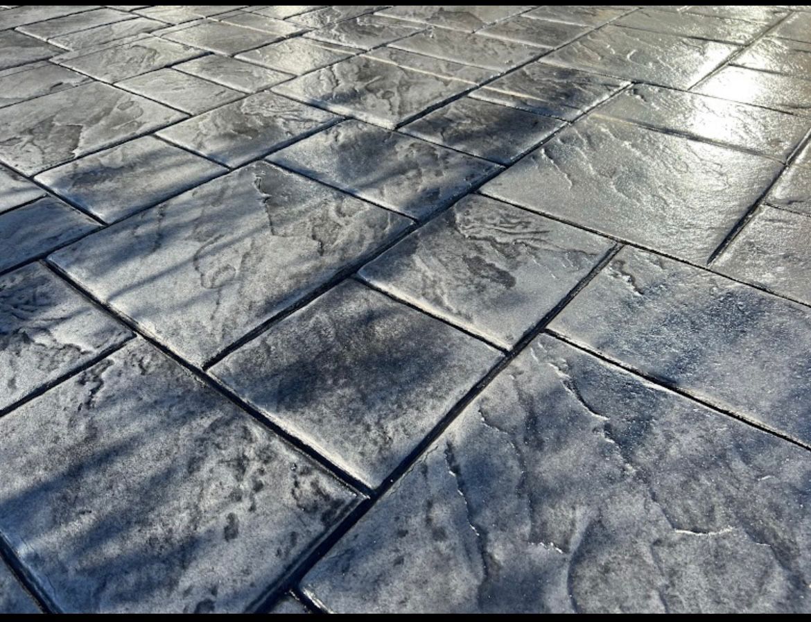 A close up of a gray tiled floor with a diagonal pattern.