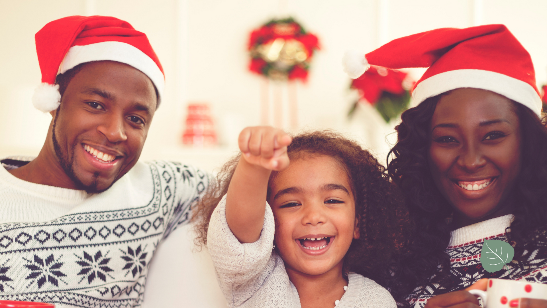 A family is posing for a picture while wearing santa hats.