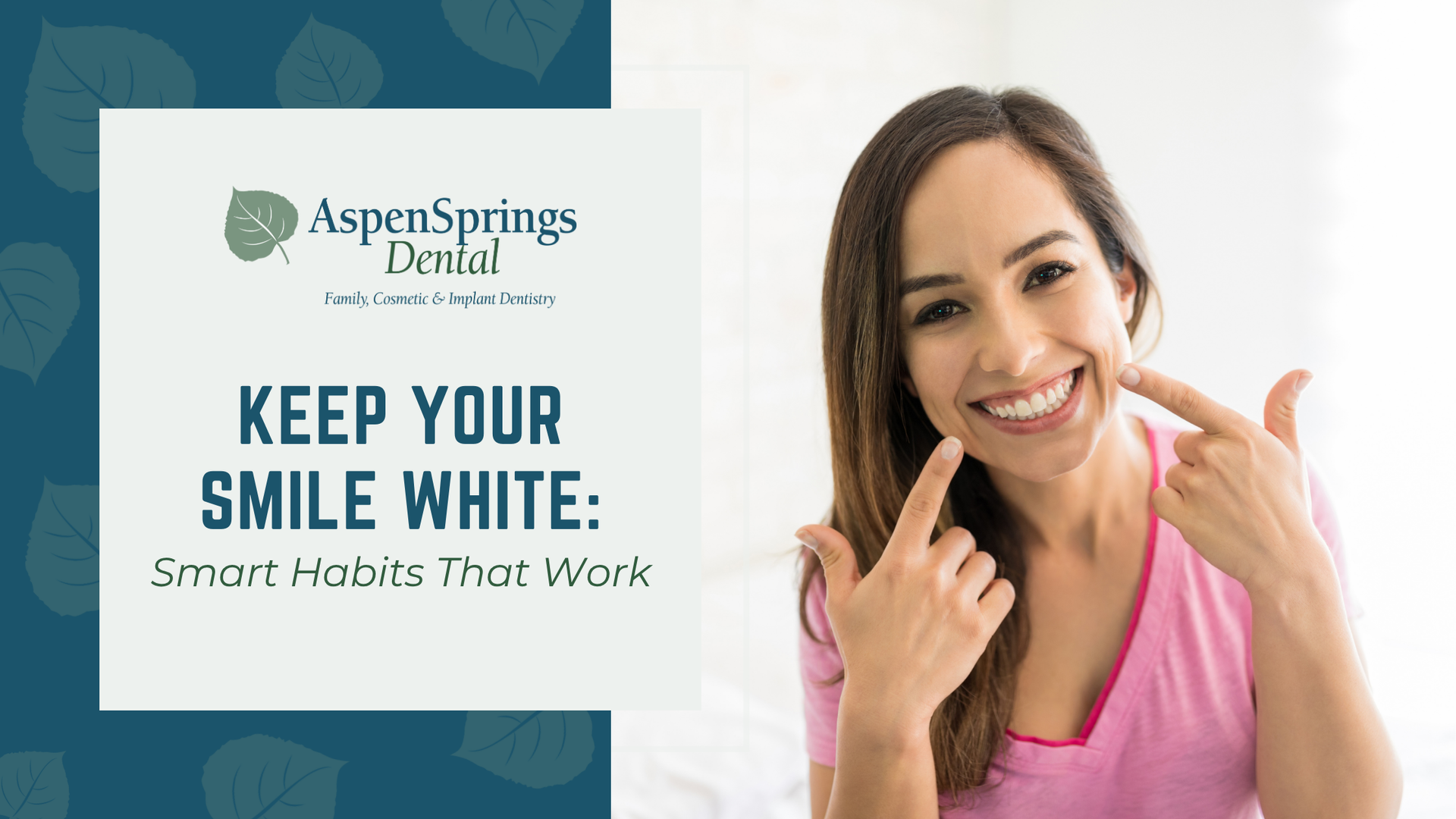A woman is smiling and pointing at her teeth.