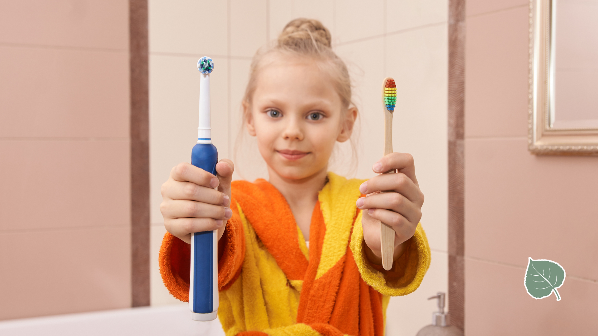 Girl in robe holding electric toothbrush and bamboo toothbrush in a bathroom.