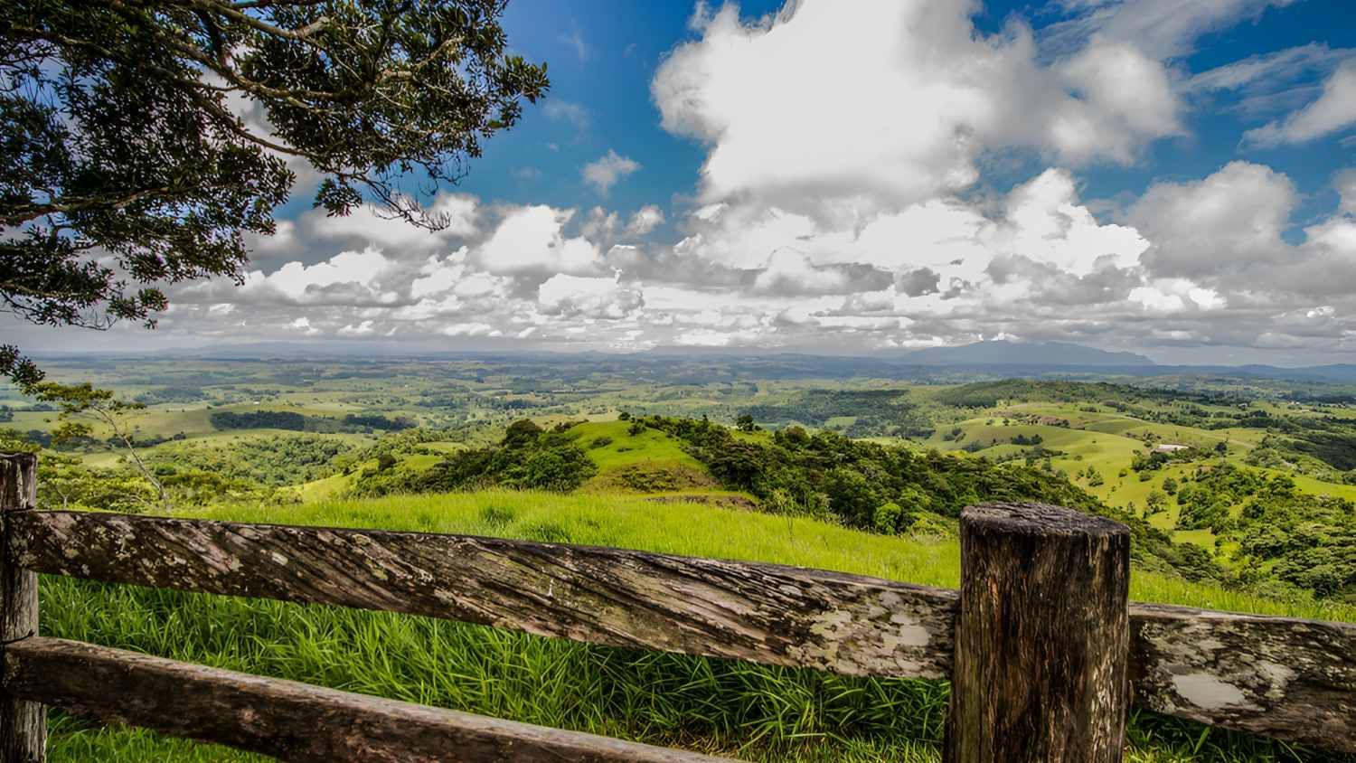 A Wooden Fence With a View of a Lush Green Hillside — Fraser Mobile Auto Tech in Tablelands, QLD