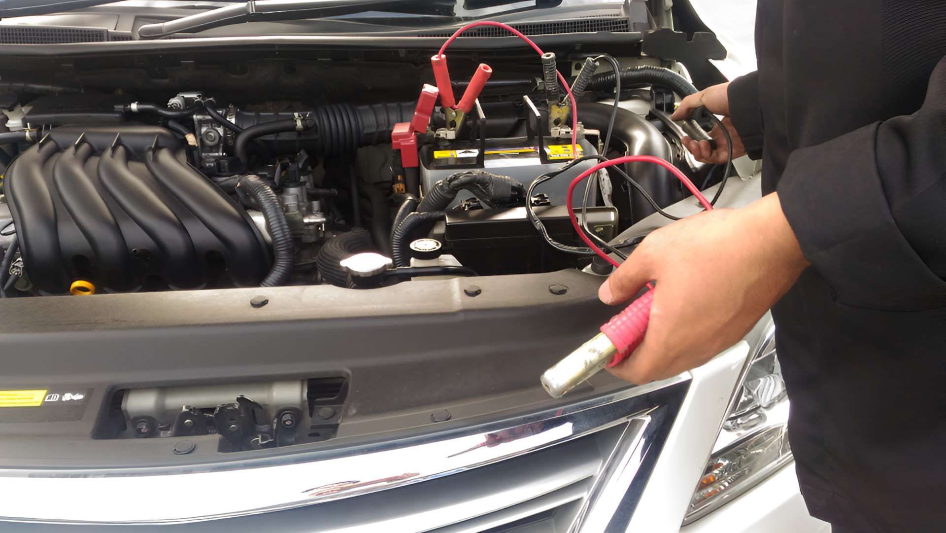 A Person is Charging a Car Battery With a Jump Starter — Fraser Mobile Auto Tech in Tolga, QLD