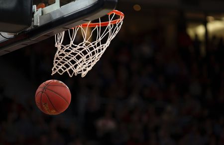 uma bola de basquete está passando pela rede de uma cesta de basquete.