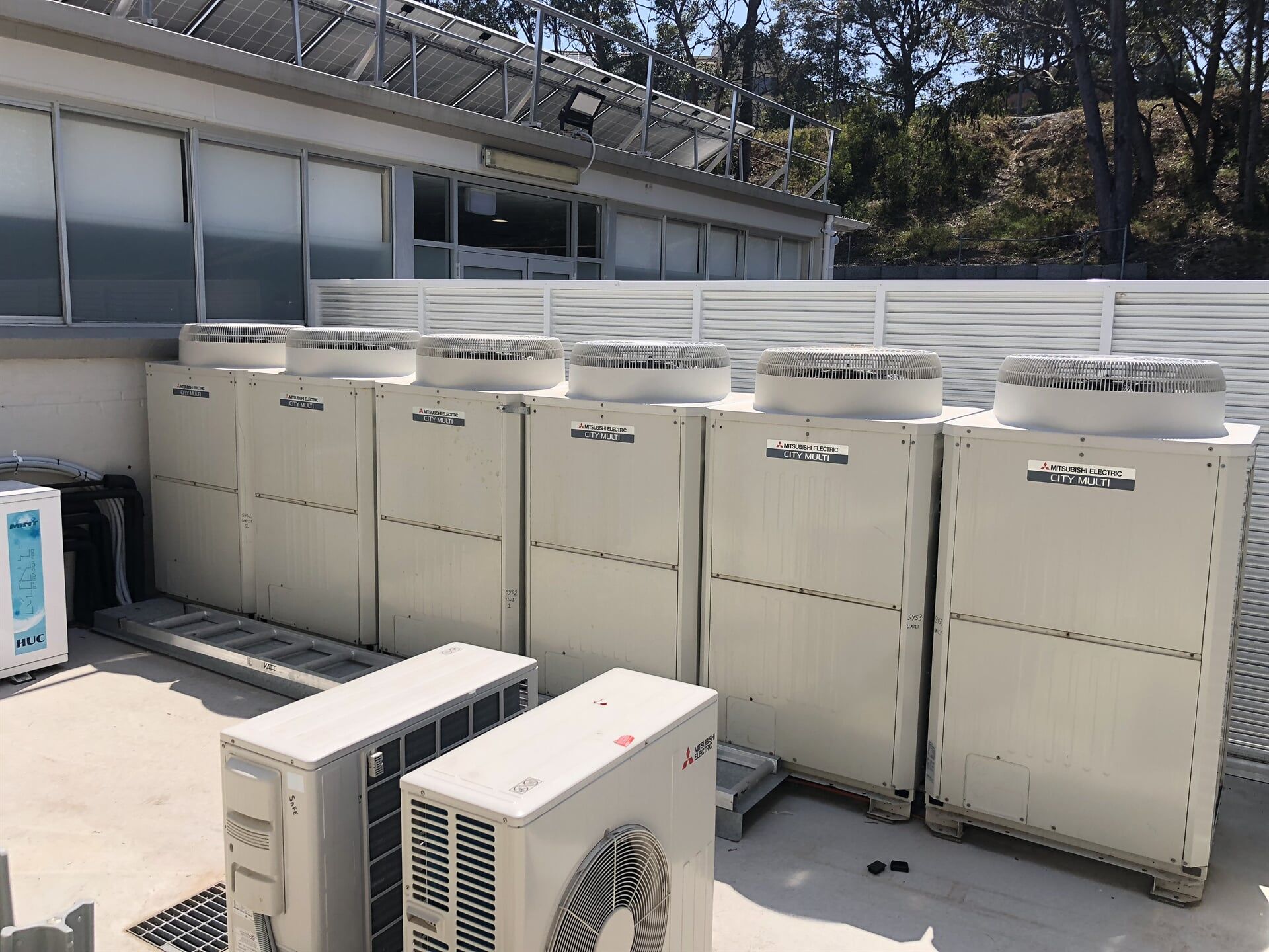 Couple operating Aircon — Residential & Commercial Airconditioning Repair in Batemans Bay, NSW