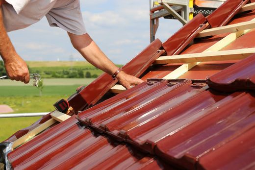 A roofing contractor is working on a new roof covering installation for a home.