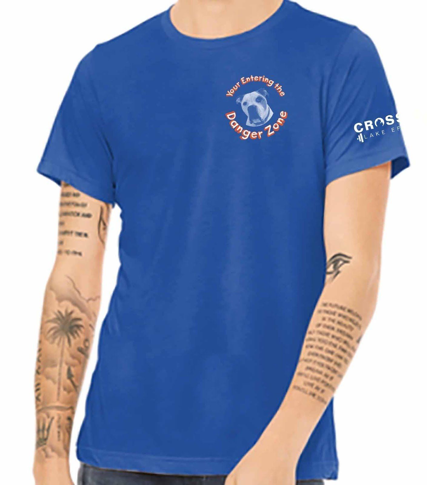 A man is wearing a blue t-shirt that says danger zone