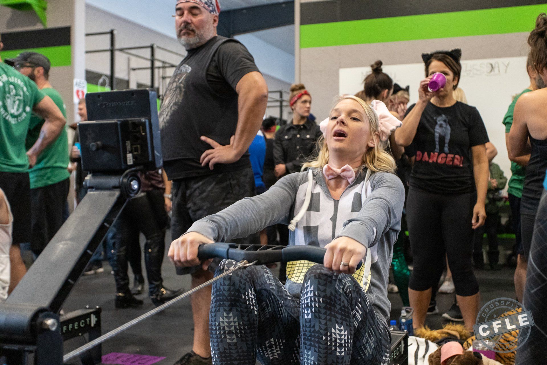 A woman is riding a rowing machine in a gym.