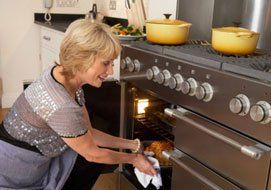 Lady cooking inside a stove - Appliance Repair in Spokane, WA