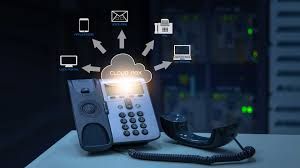 A telephone is sitting on a table with a cloud connected to it.