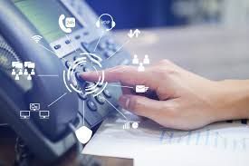 A person is pressing a button on a telephone.