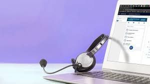 A pair of headphones with a microphone attached to a laptop computer.