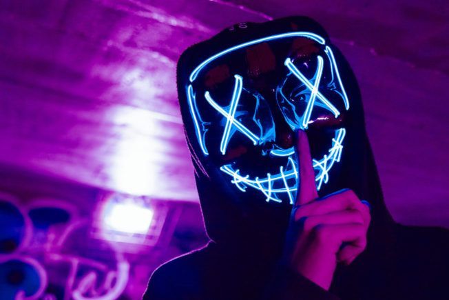 DJ Wearing LED Purge Mask Doing Silence Gesture