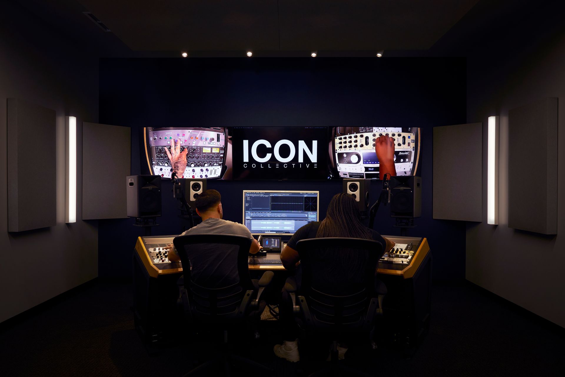a man and a woman sit in a mastering studio at icon collective