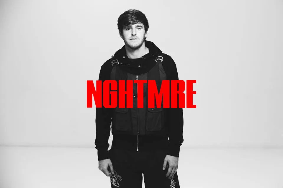 A man is standing in front of a sign that says nightmare