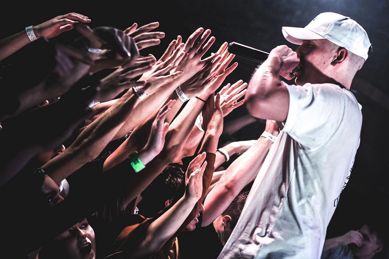 White Rapper on Stage with Fans 