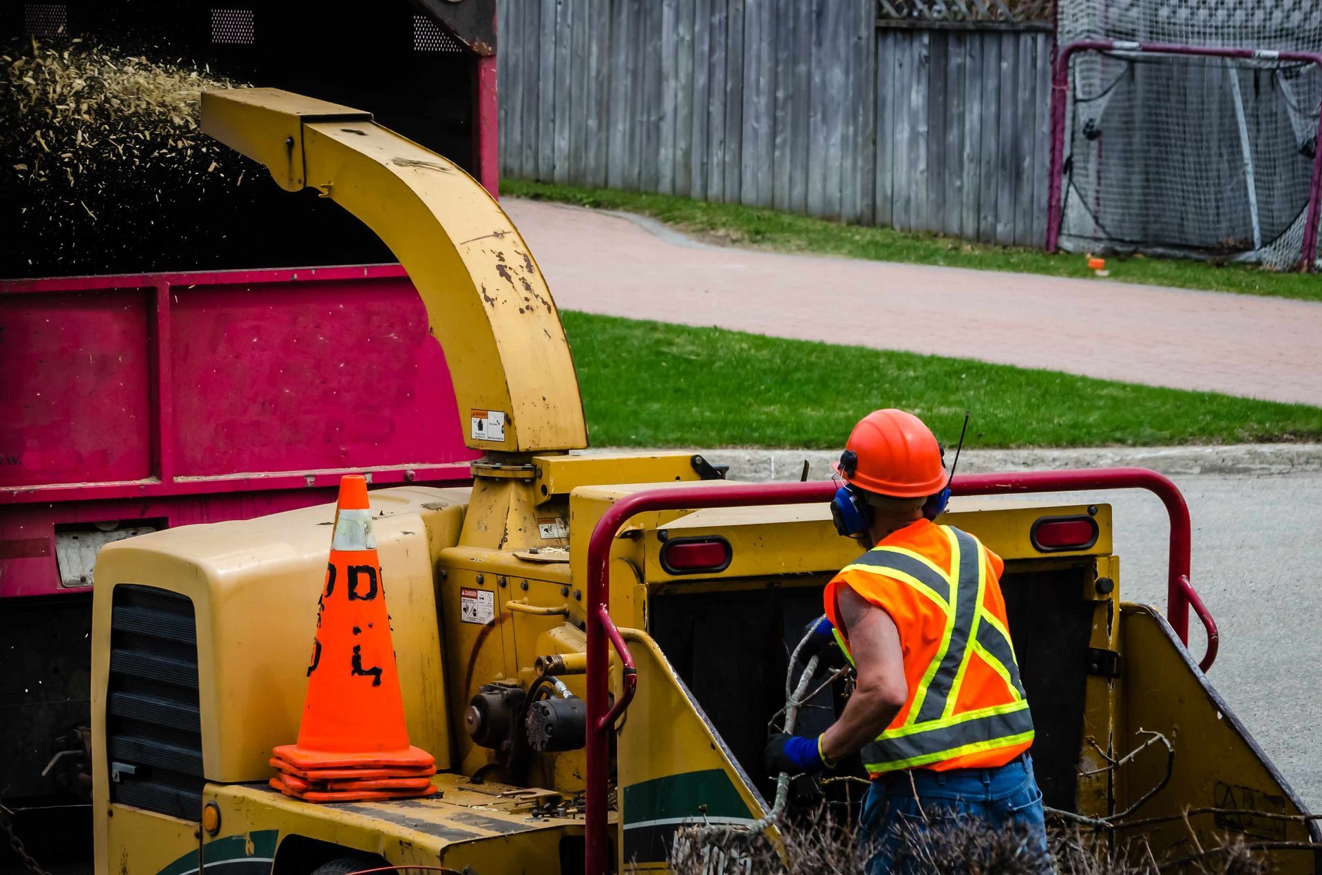 A man riding on a wood-chipping machine