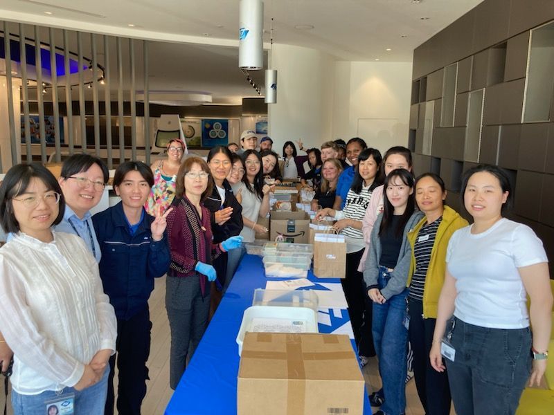 Fuyao Glass Company employees assembling art kits for We Care Arts Transition To Work program.