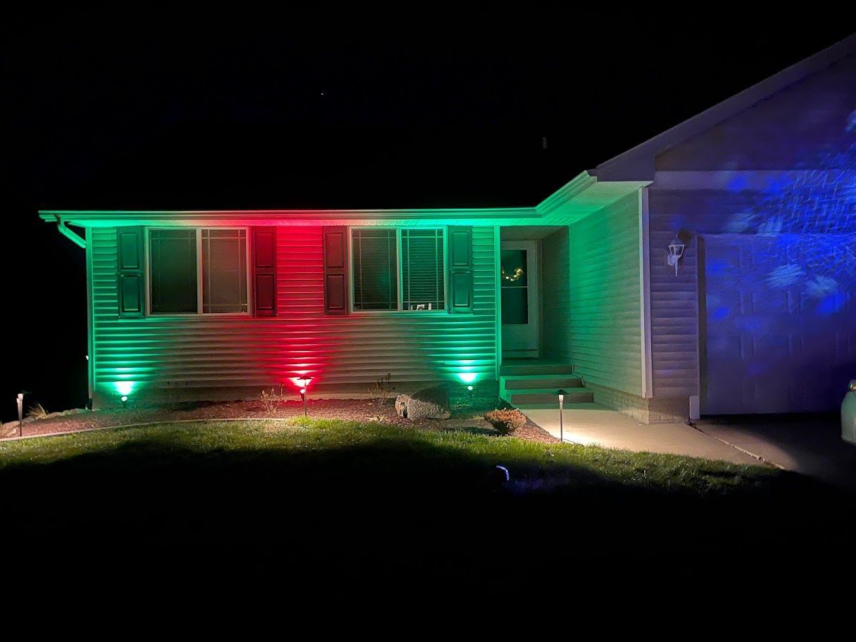 A house is lit up with red and green lights at night.