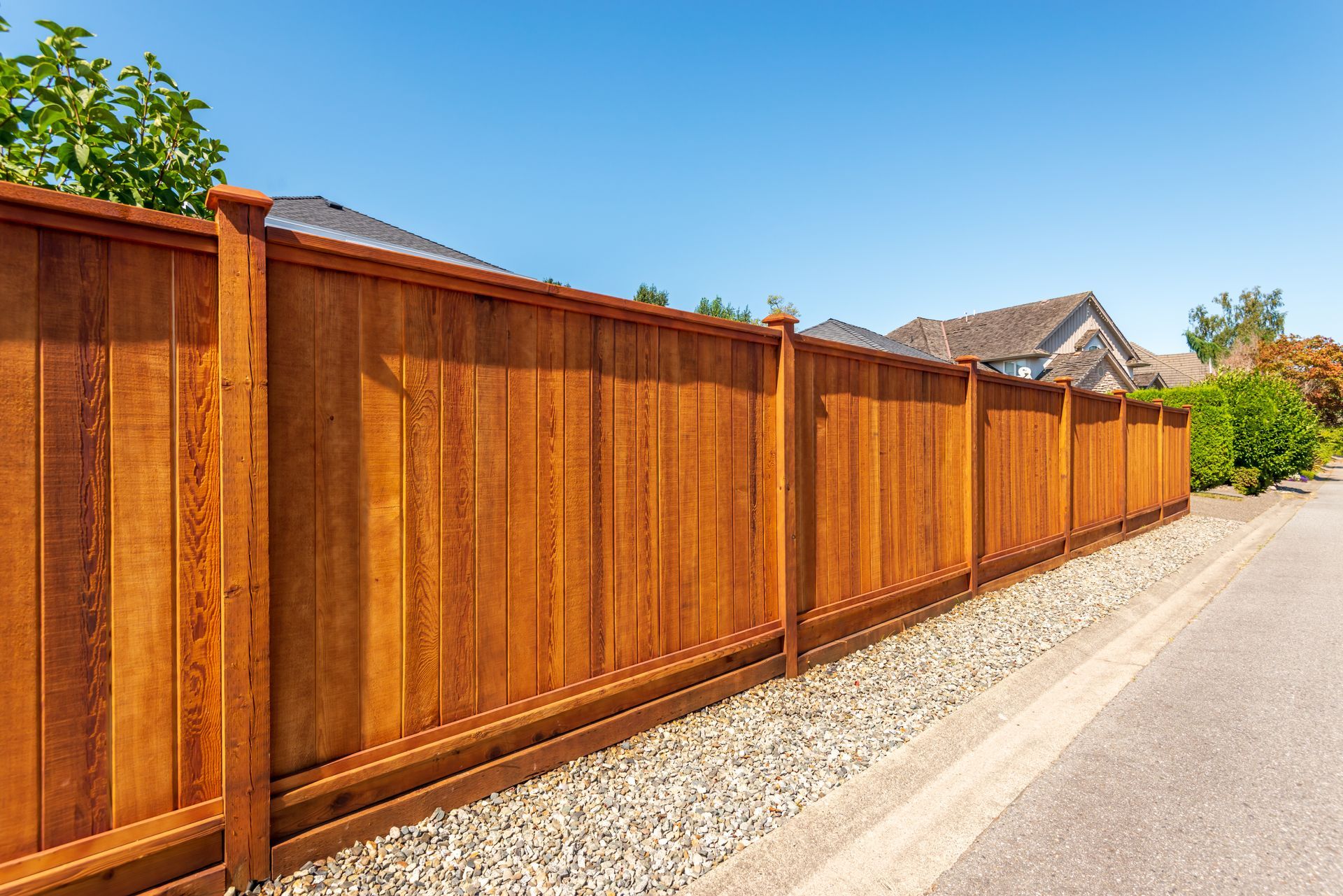 Wooden fence surrounding outdoor landscape, providing security and privacy.