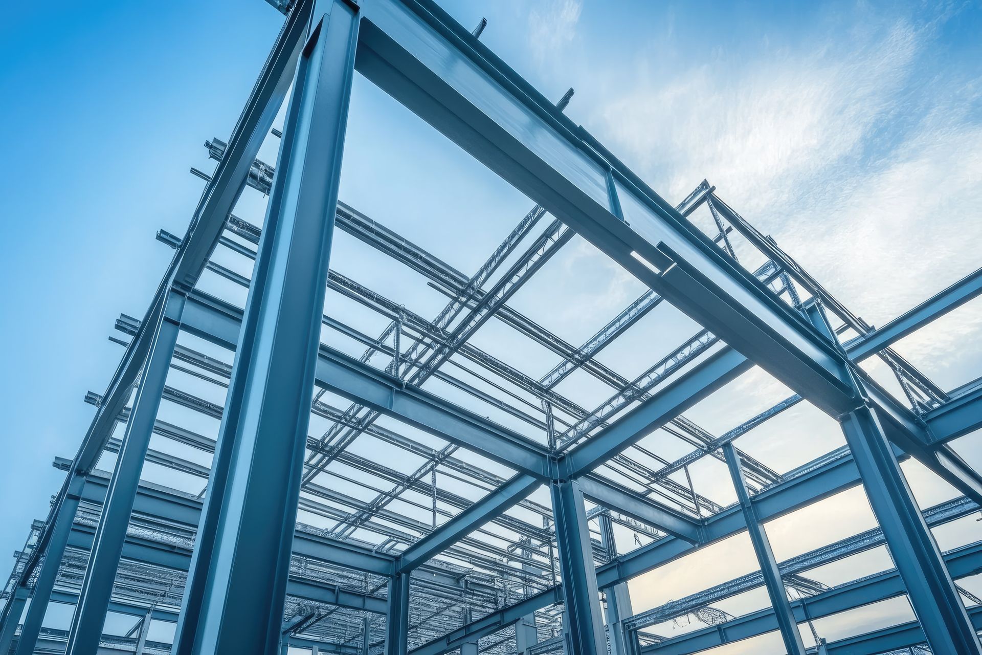 A building under construction with a blue sky in the background.