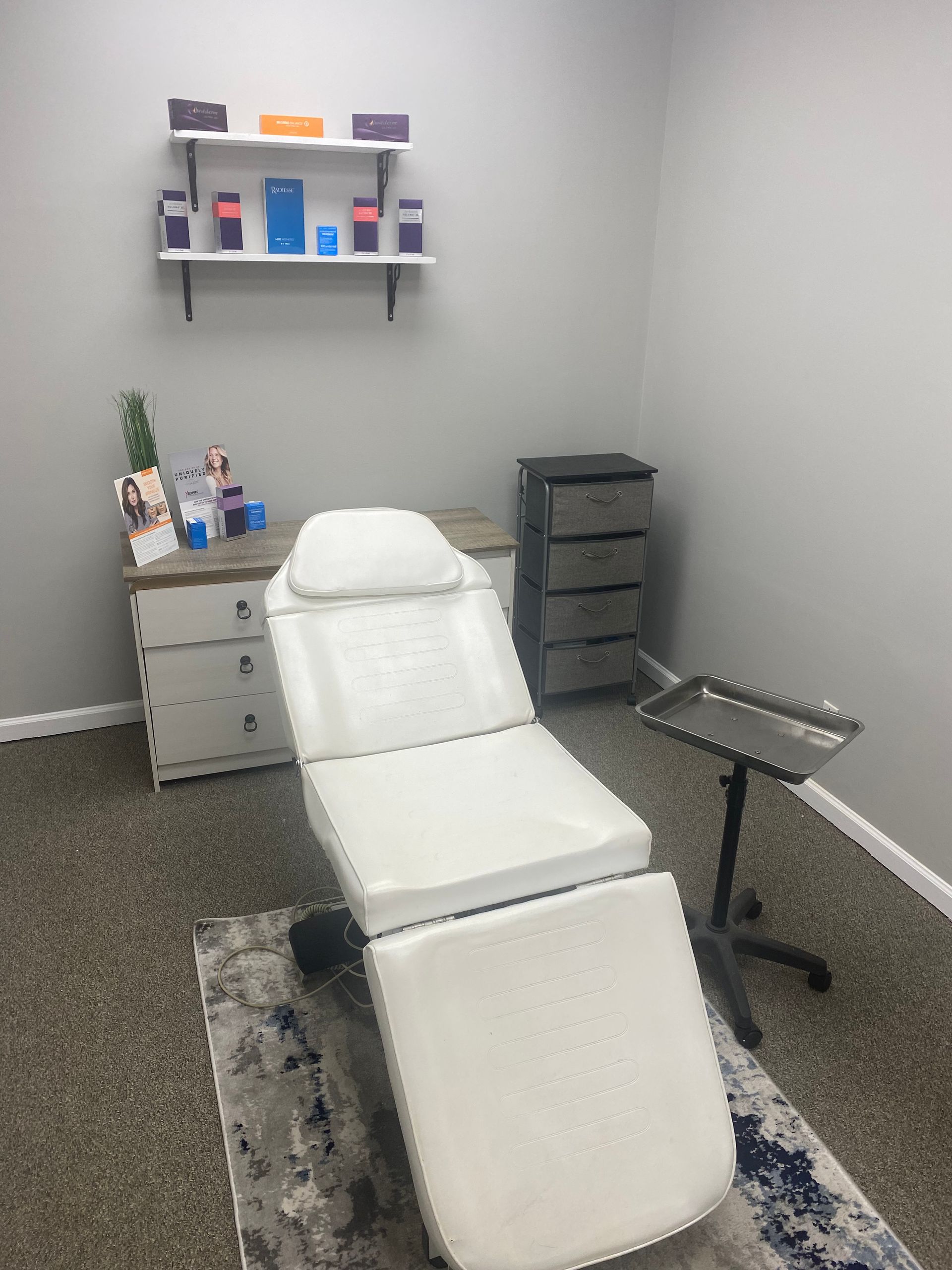 There is a white chair in the middle of the room.