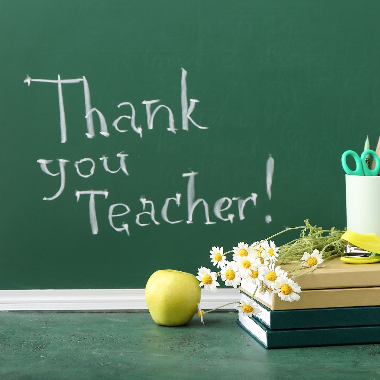 A chalkboard with the words thank you teacher written on it