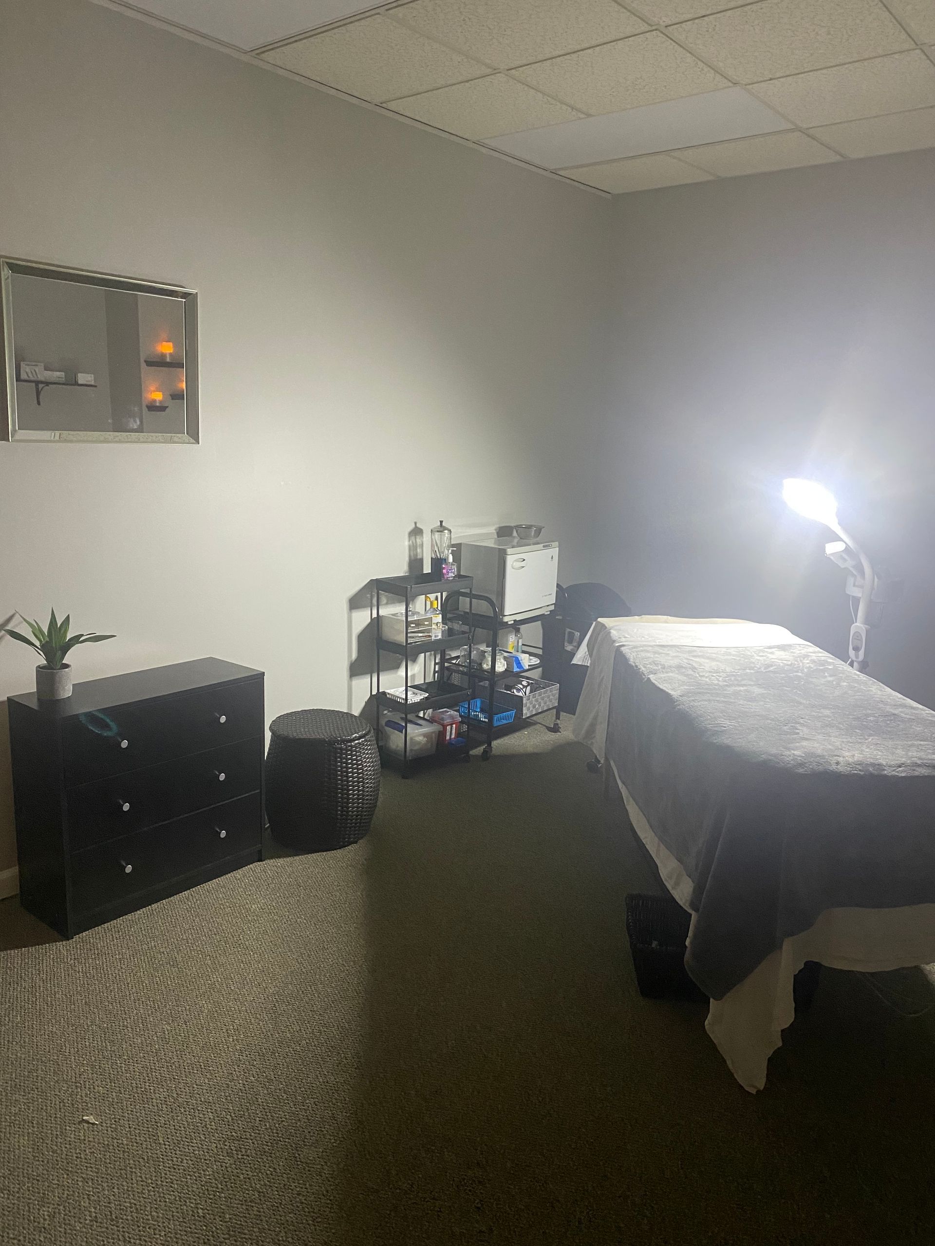 There is a massage table in the middle of the room.