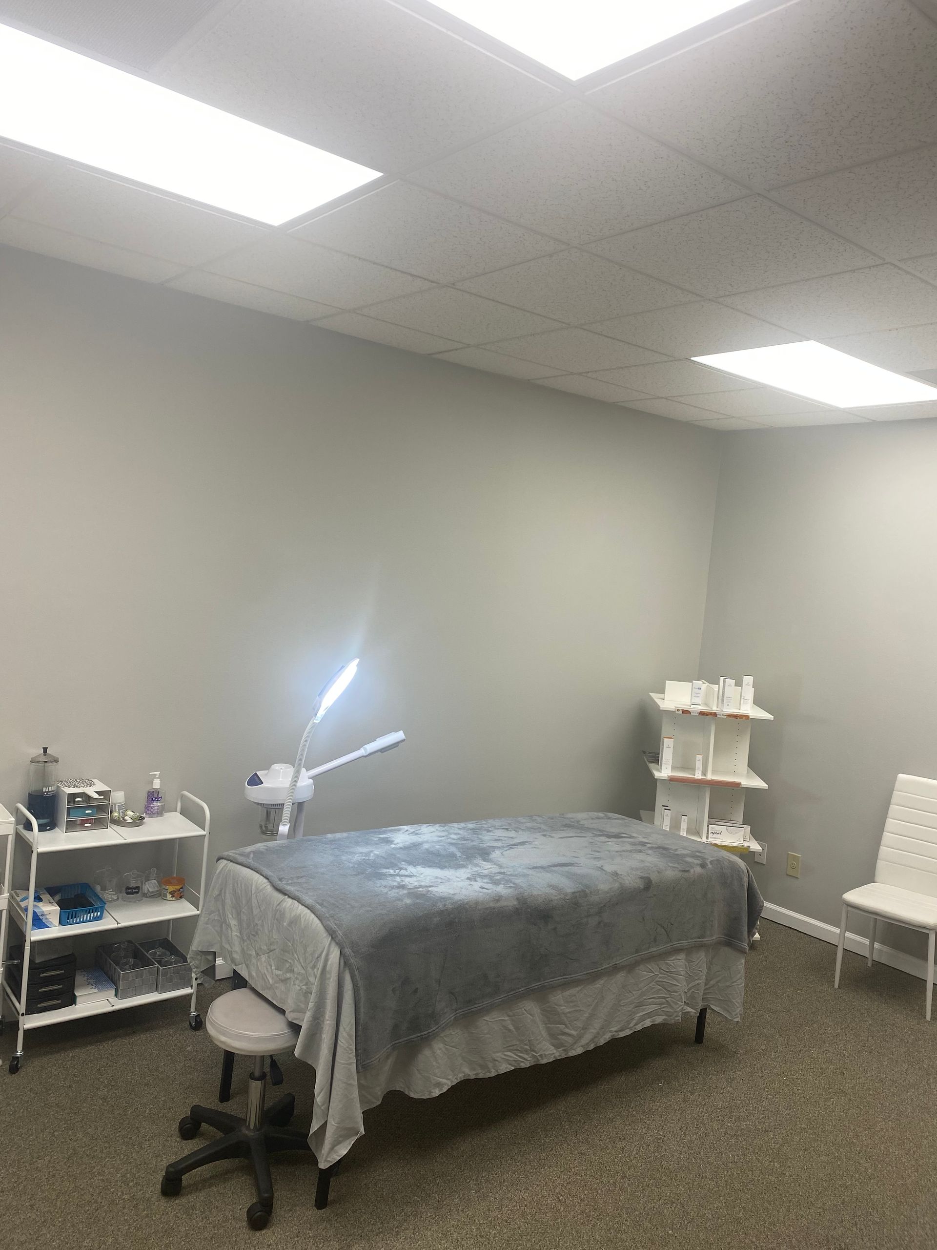 There is a massage table in the middle of the room.