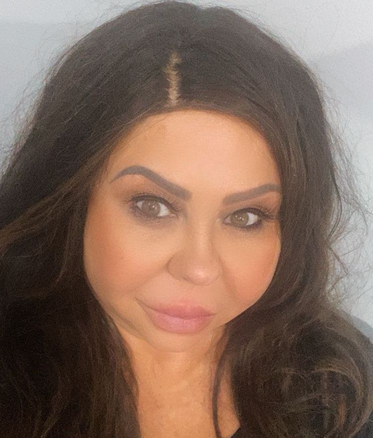 A close up of a woman 's face with long hair.