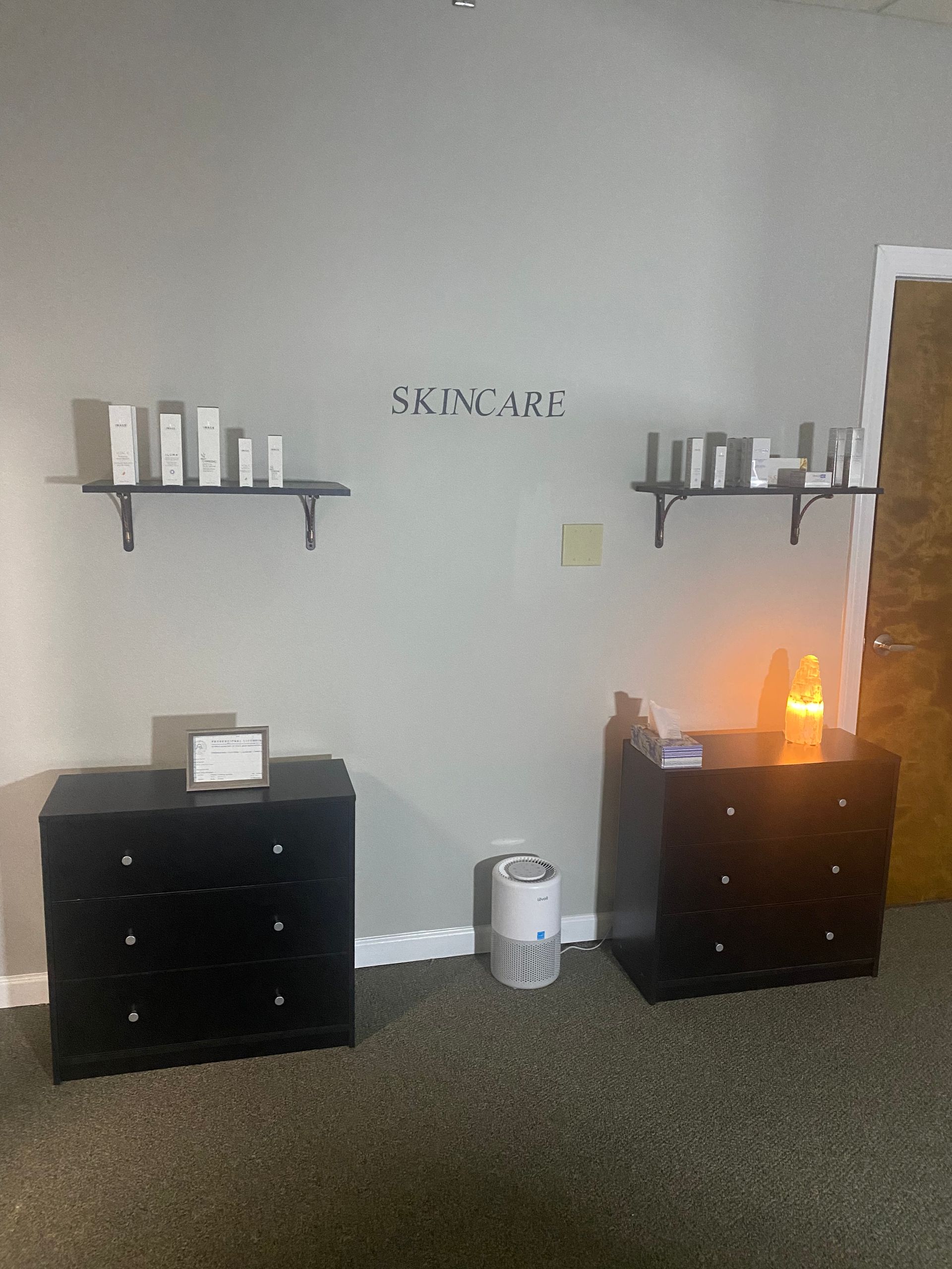 A room with two dressers and a wall that says skincare on it.