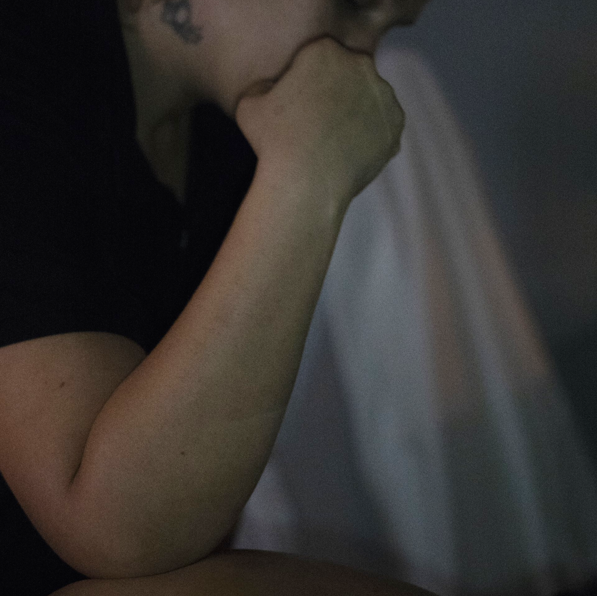 A close up of a person 's hand on their chin