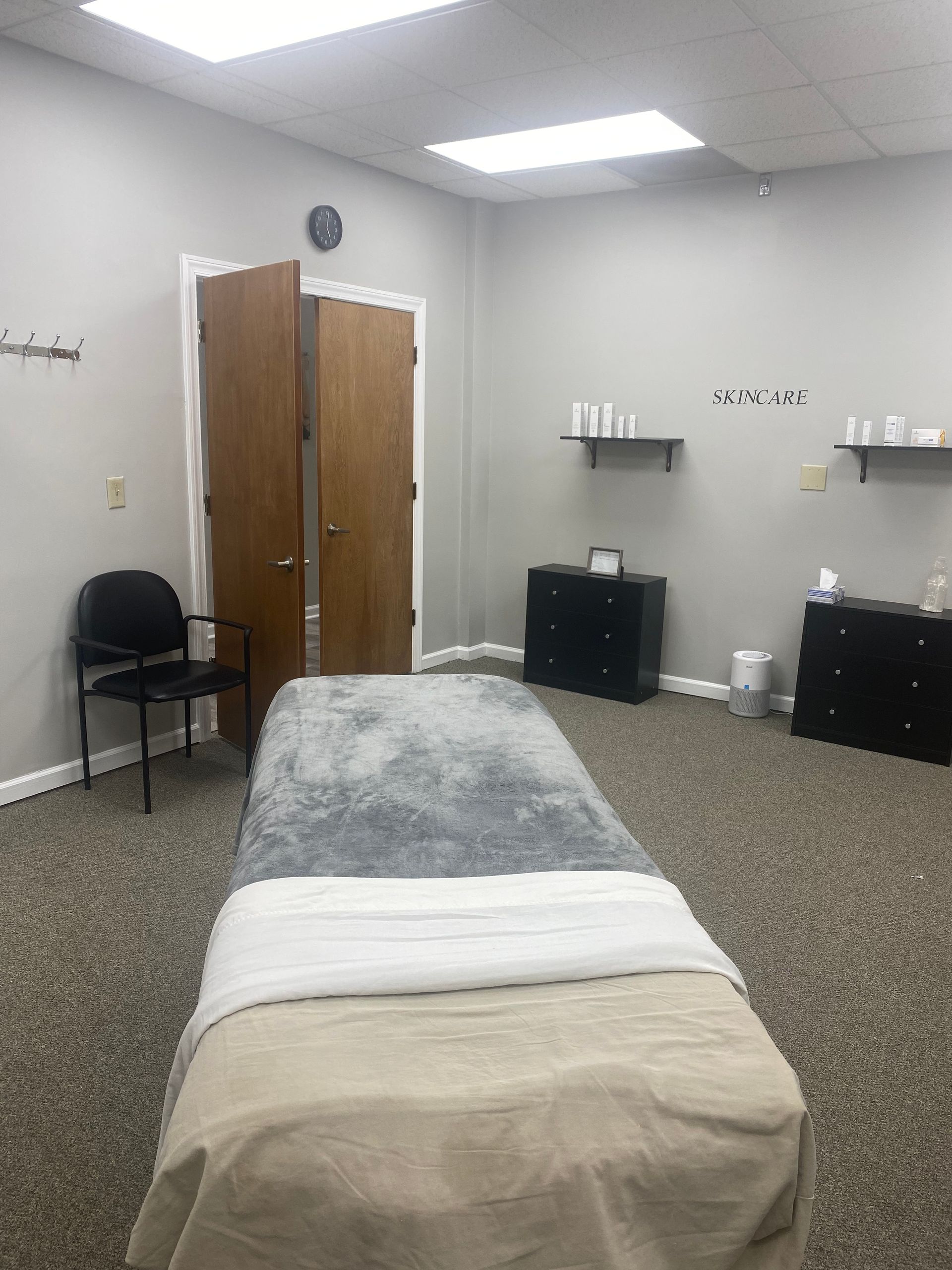 There is a massage table in the middle of the room.