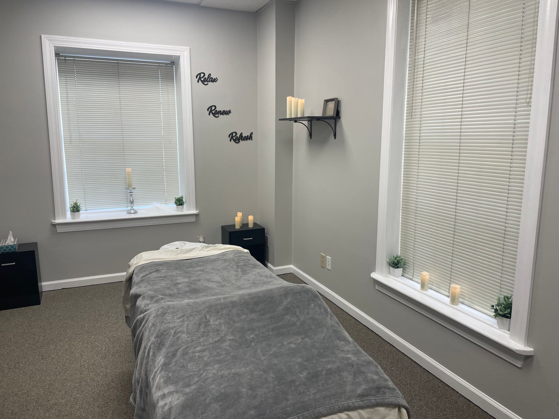 There is a massage table in the middle of the room.