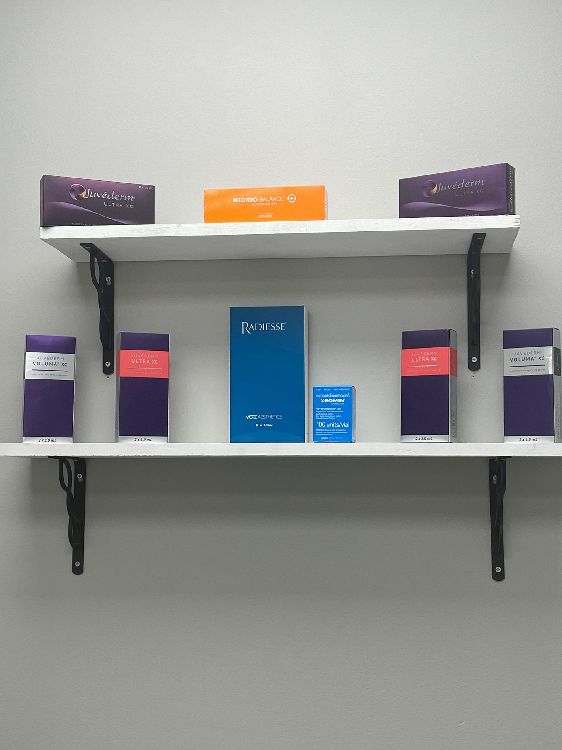 A white shelf with a blue book on it