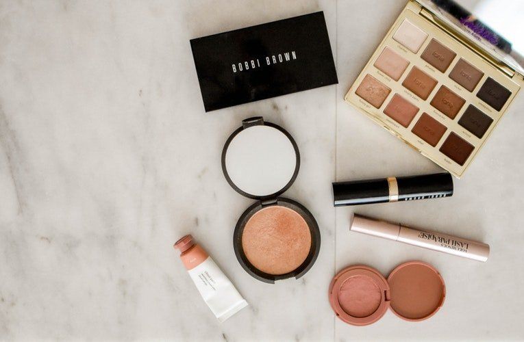A table topped with a variety of makeup products.
