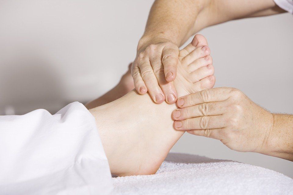 A person is getting a foot massage from a massage therapist.