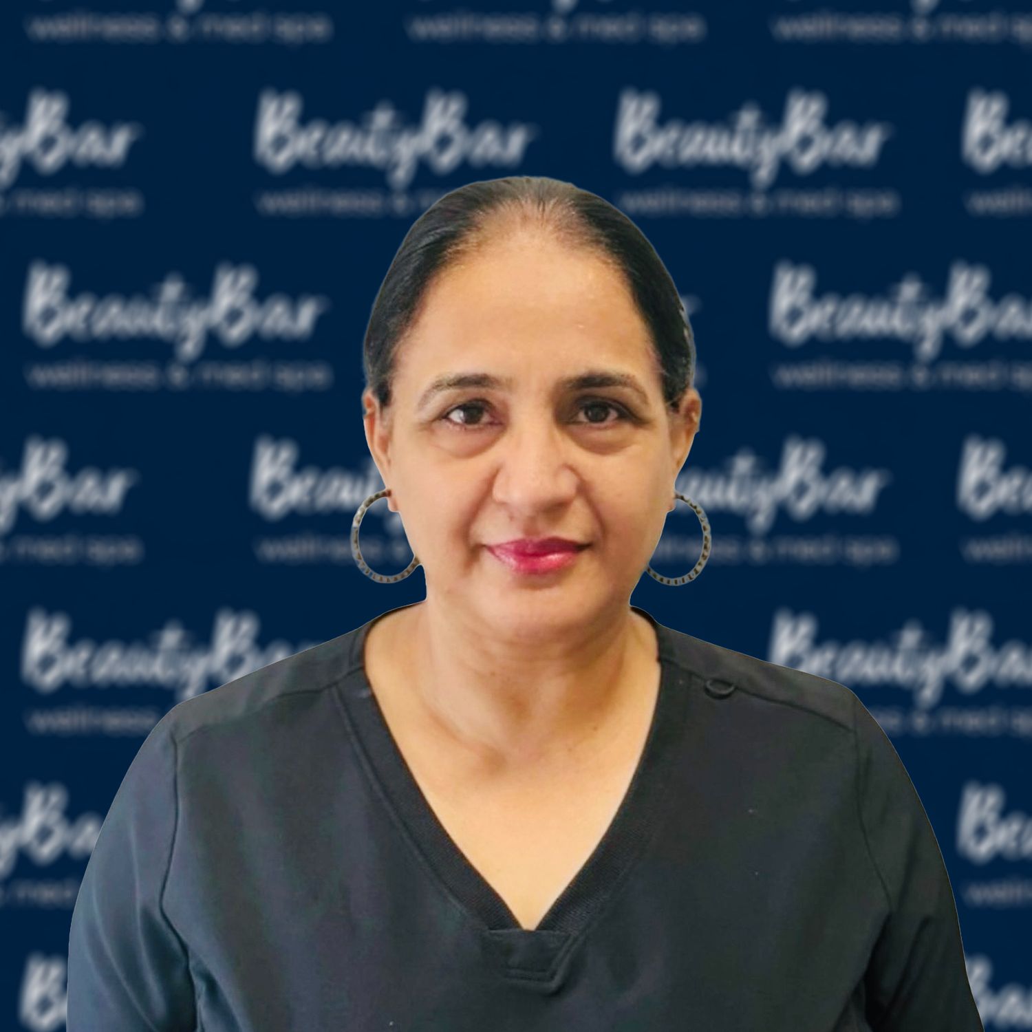 A woman wearing glasses and hoop earrings is smiling for the camera.