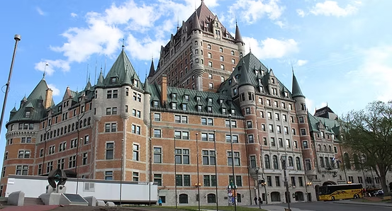 Multi-story building with ornate facade and balconies, contrasting with a plain white side.