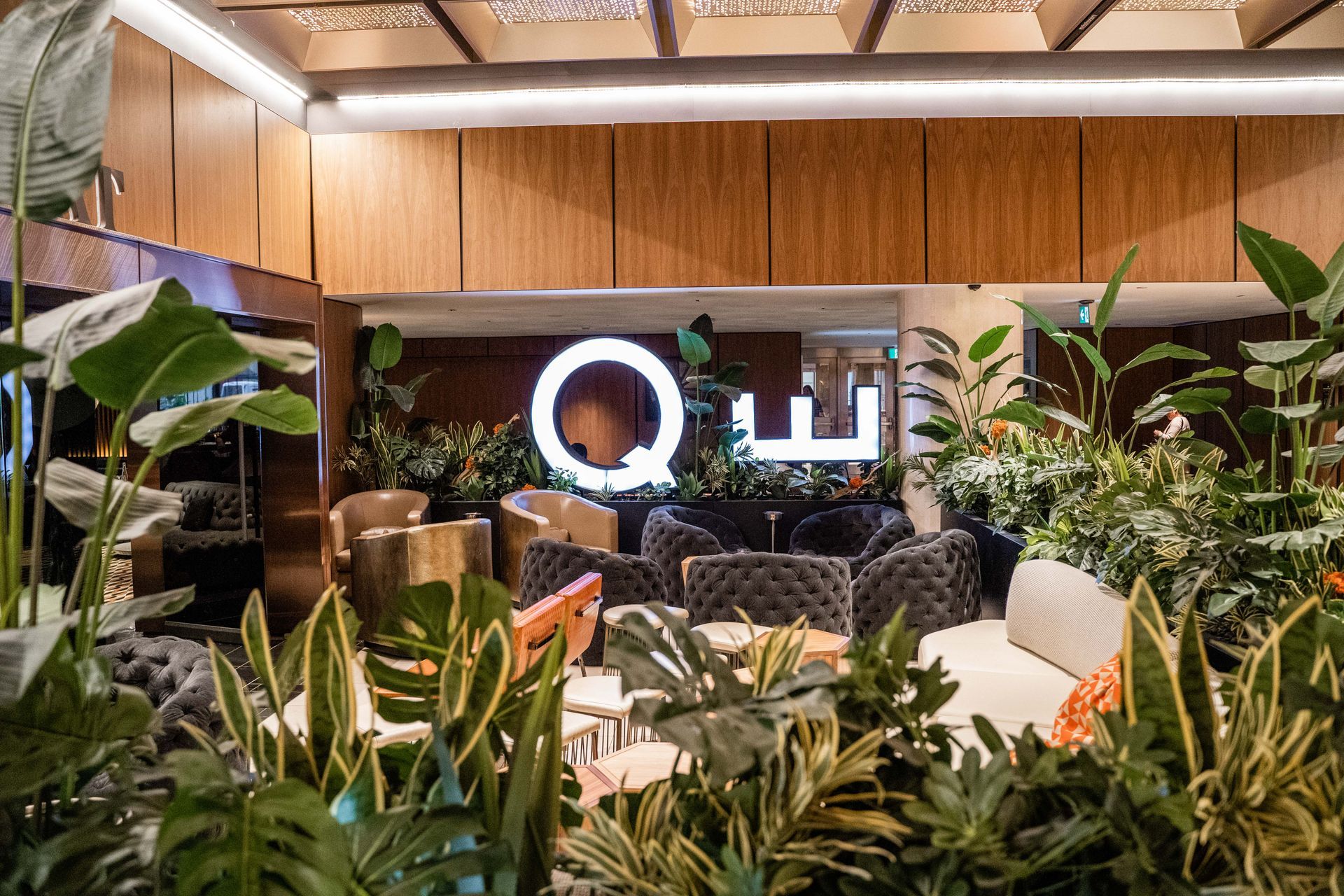 Multi-story building with ornate facade and balconies, contrasting with a plain white side.
