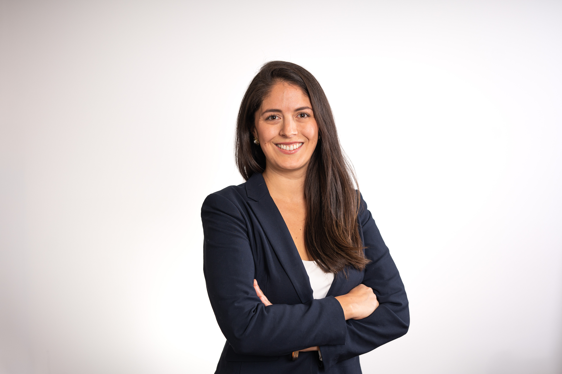 Modern kitchen with island, wooden shelves, dark cabinets, fruit bowl, and three pendant lights.