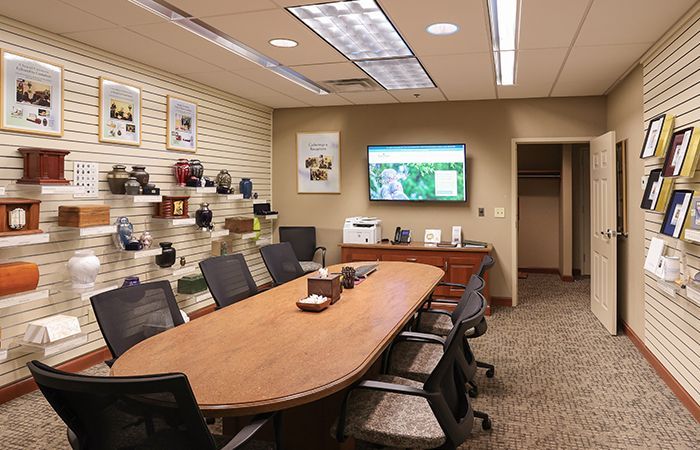 a conference room with a table and chairs and a computer on the desk