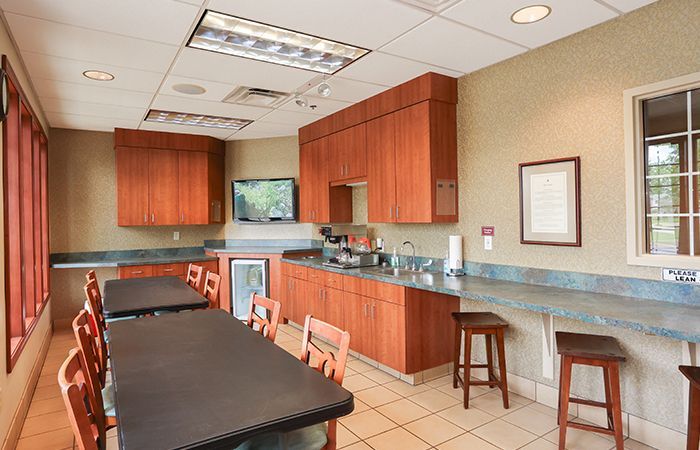 a room with tables and chairs and a picture on the wall .
