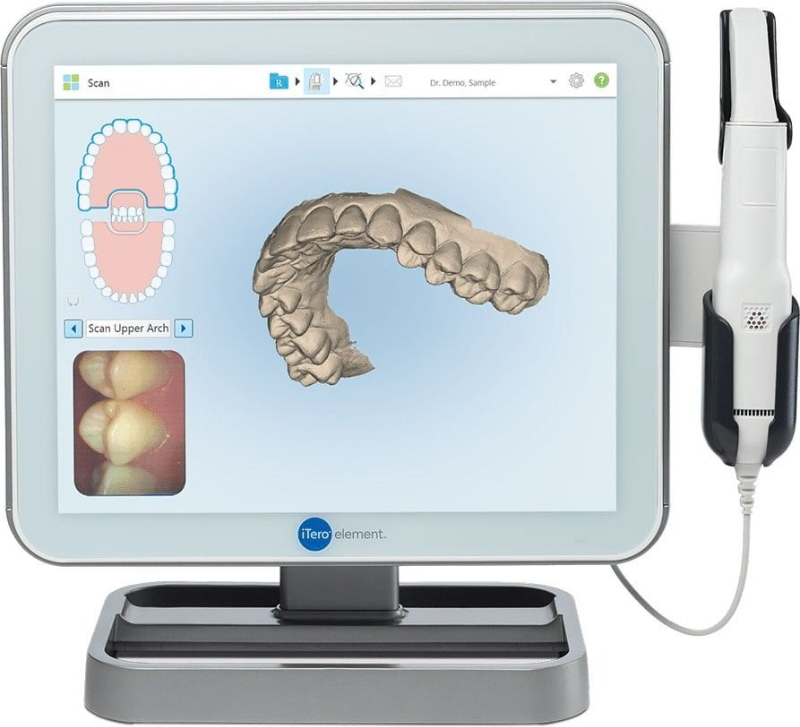 Dental scanner display showing a 3D model of teeth and a handheld intraoral scanner on a stand