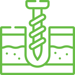 A screw is being drilled into a hole in the ground.