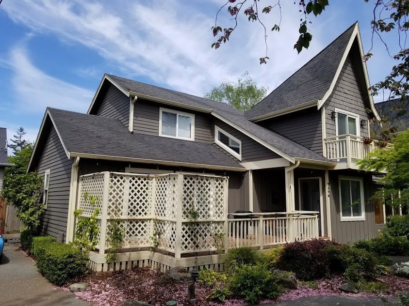 A large house with a gray roof and white trim