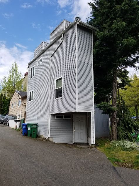 A very tall house with a garage underneath it