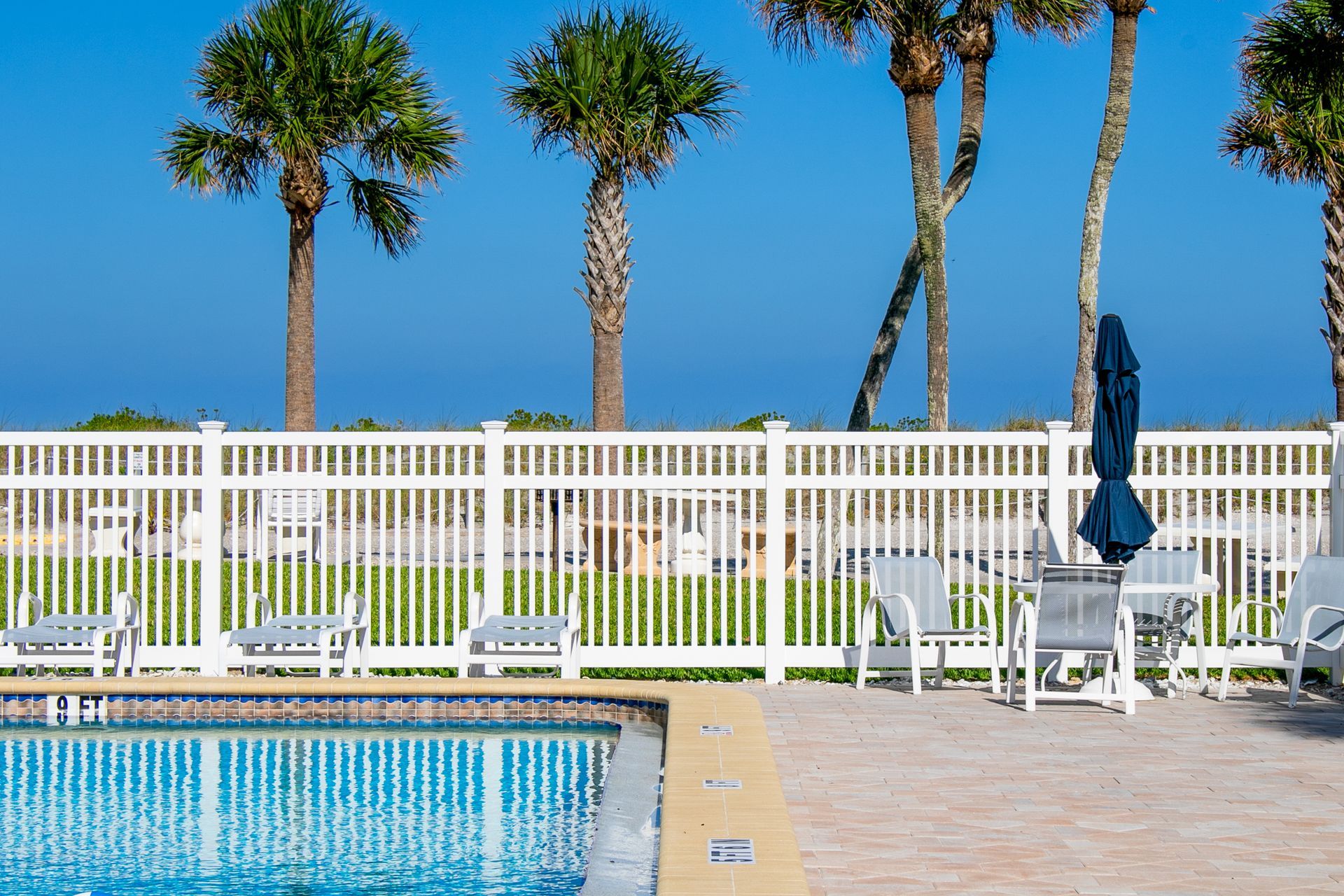 white fence by the pool